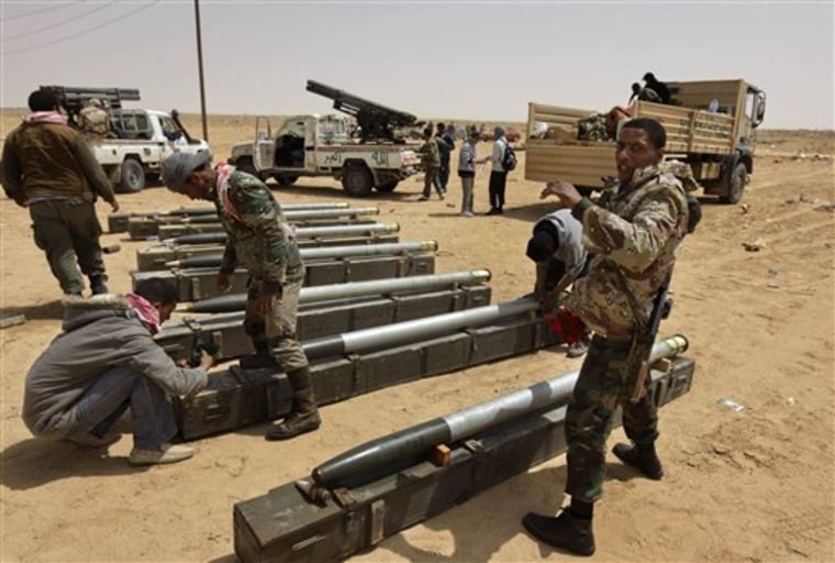Libyan rebel fighters prepare rockets for use at a position west of Ajdabiya, Libya, on Wednesday.